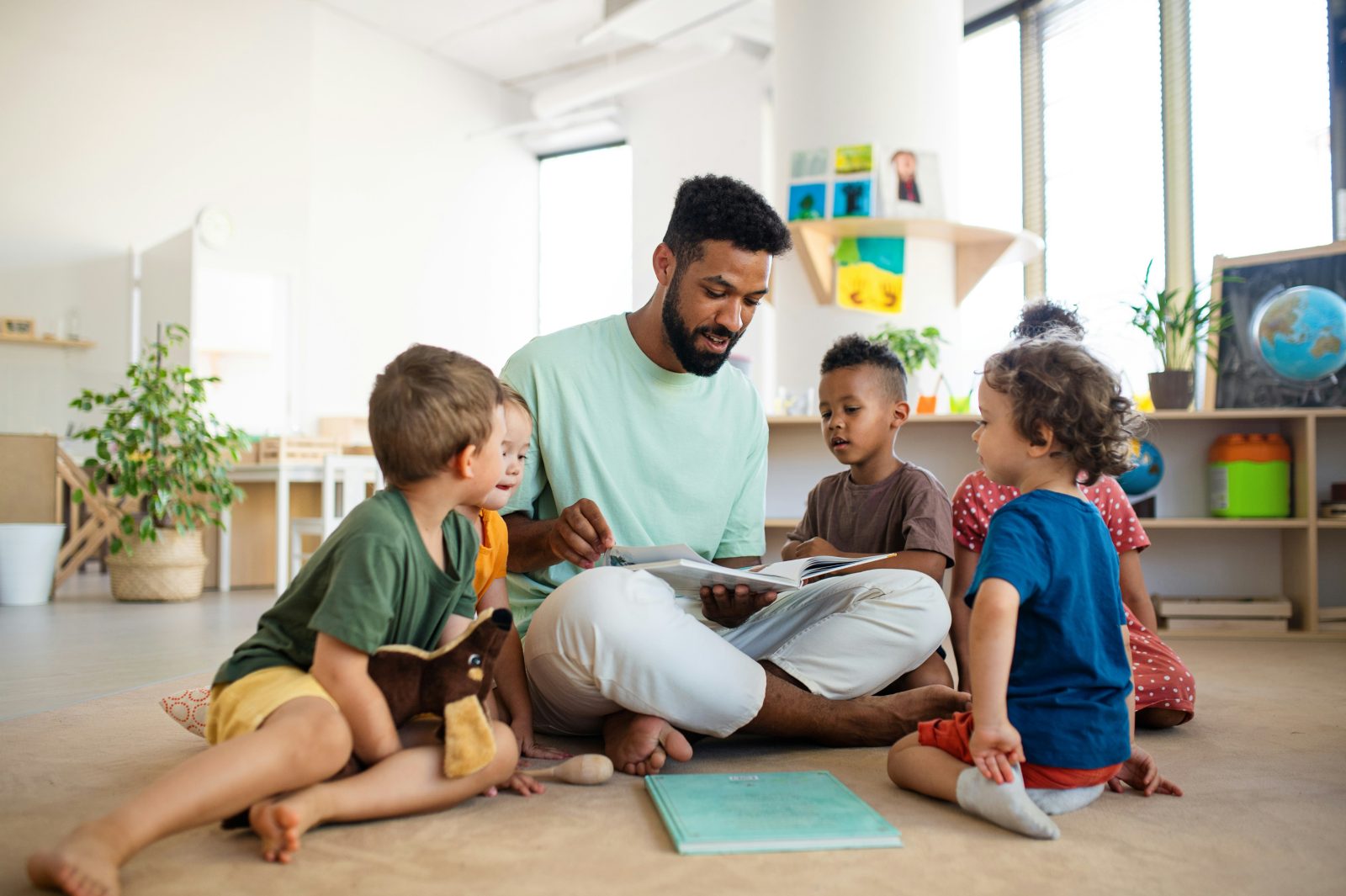 Teacher reading with a group of preschool children